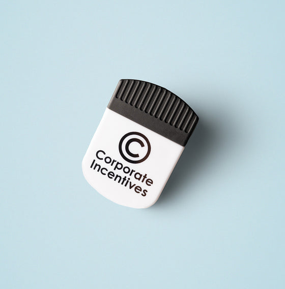 Small white device with black top labeled 'Corporate Incentives' on a light blue background